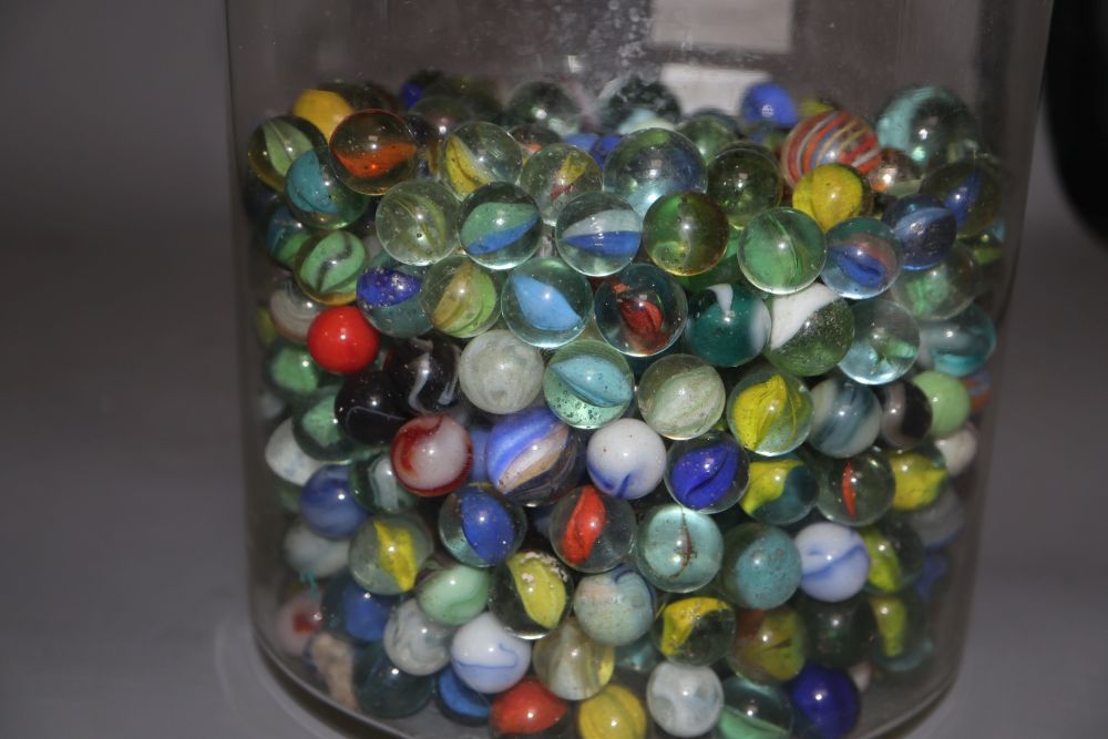 A glass jar and cover containing Victorian and later coloured marbles, height 26.5cm